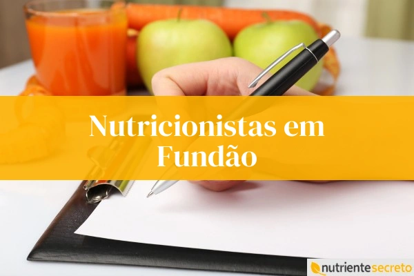 Nutricionistas em Fundão, laranja e maçãs no fundo